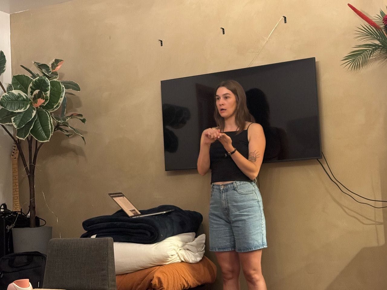 A speaker mid-talk in front of the TV