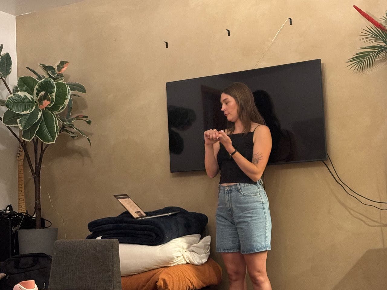 The speaker, hands together, mid-point