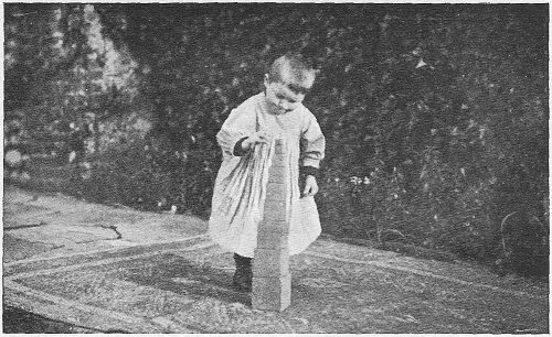 A small child balancing the last block of the Tower